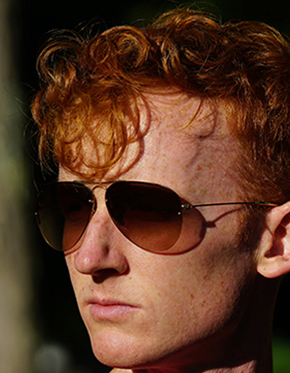Young man’s color photo of face wearing sunglasses