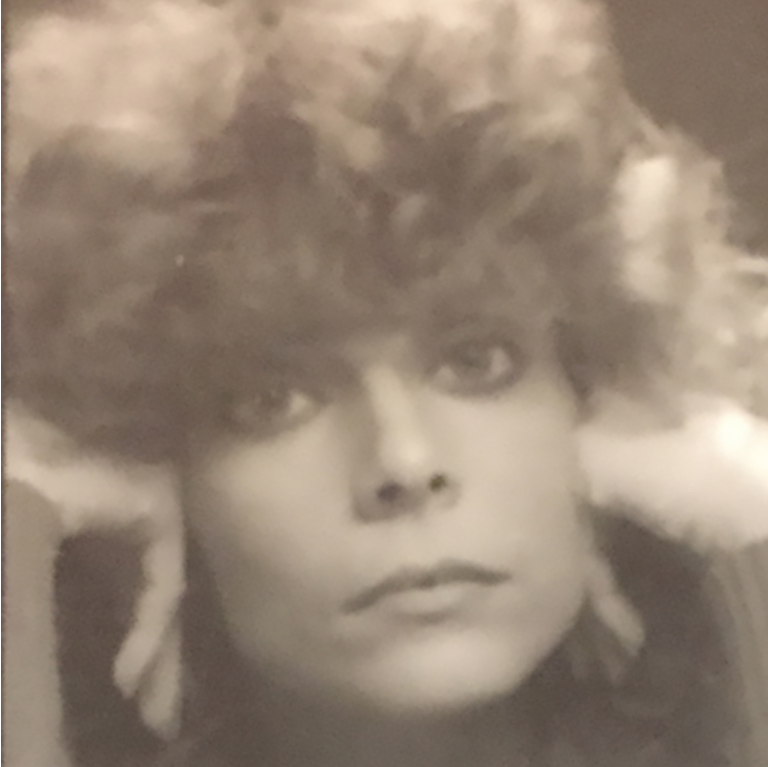 Black and white photo of young woman serious expression with curly hair